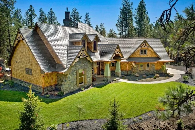 Craftsman home with a pristine emerald front lawn