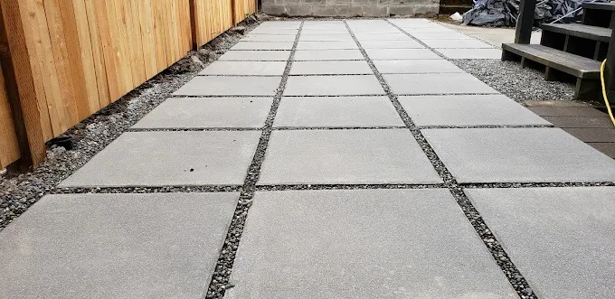 Modern large-format concrete pavers with dark gravel joints