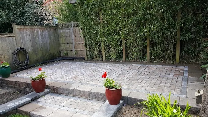 Paver patio with a bamboo privacy screen