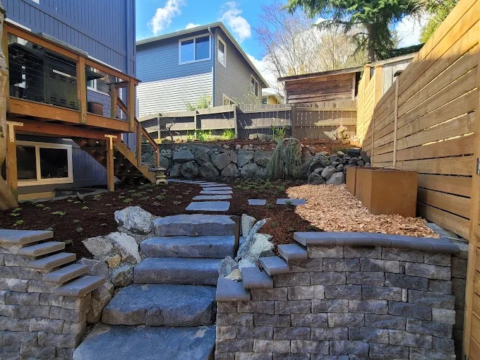 Terraced backyard with natural stone steps and block seat walls